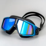 Blue mirrored HD anti-fog prescription swim goggles for myopia, with adjustable silicone strap, shown on a watery background.